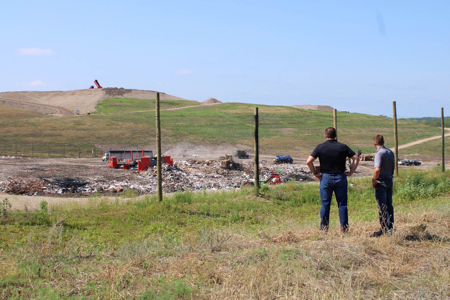 Jason Haus and Mark Pahl, owners, stand in front of the landfill